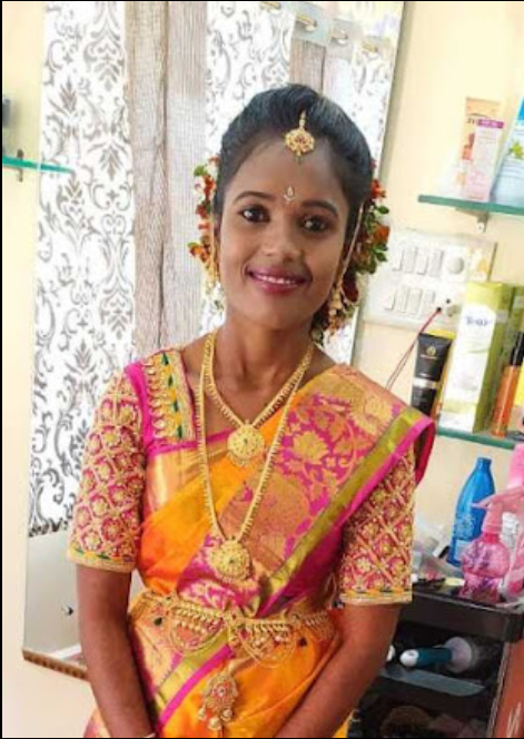 Client in orange silk saree with gold jewelry